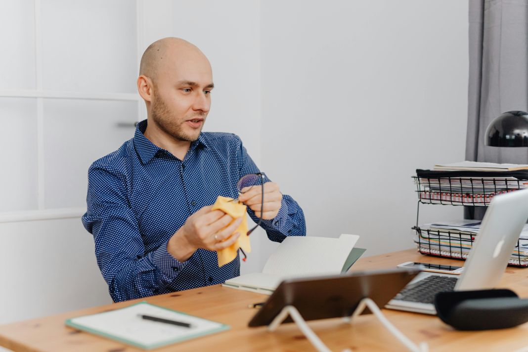 a photo of an office worker looking over the cleaning checklist