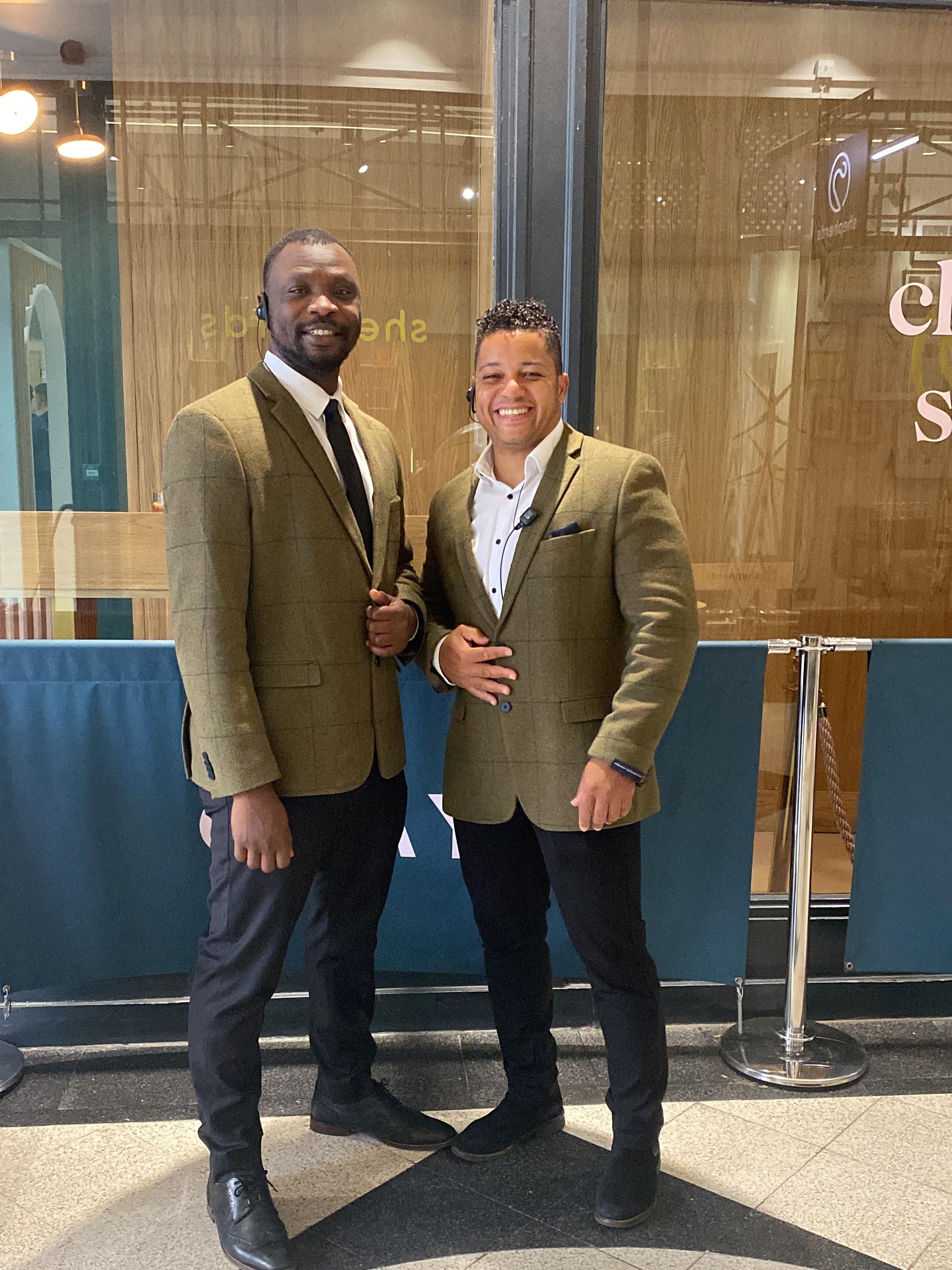 a photo of professionally dressed x2 male security guards