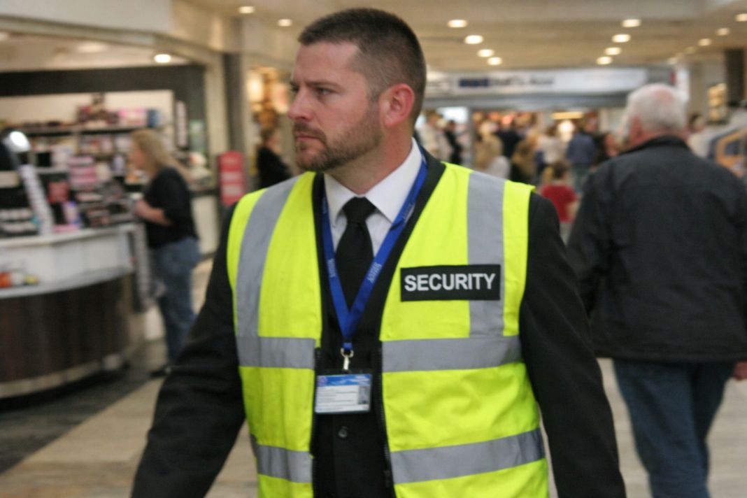 A representative image of a shopping centre security guard on patrol