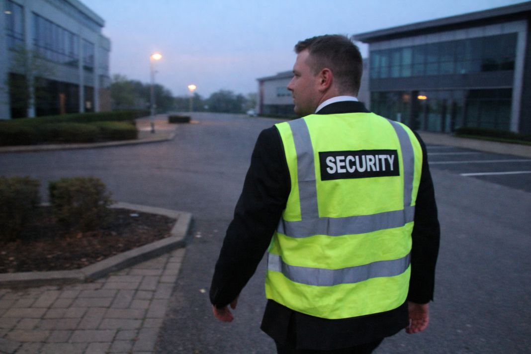 A representative image of security walking through an empty business park during early morning hours