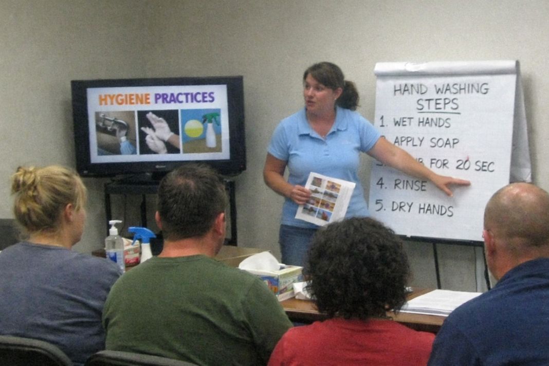 A representative photo of a training session where employees learn hygiene practices