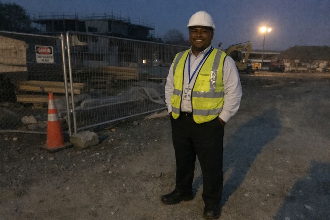 an ai photo of a construction site security guard working in the early hours