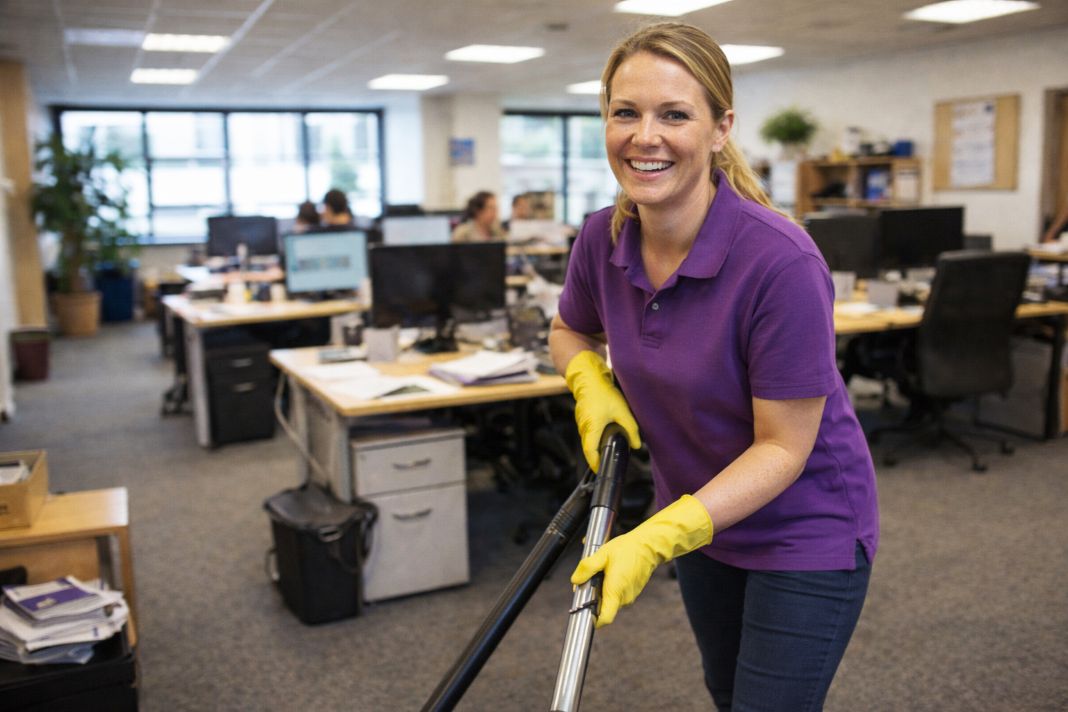 an ai photo of an office cleaner cleaning an office after hours