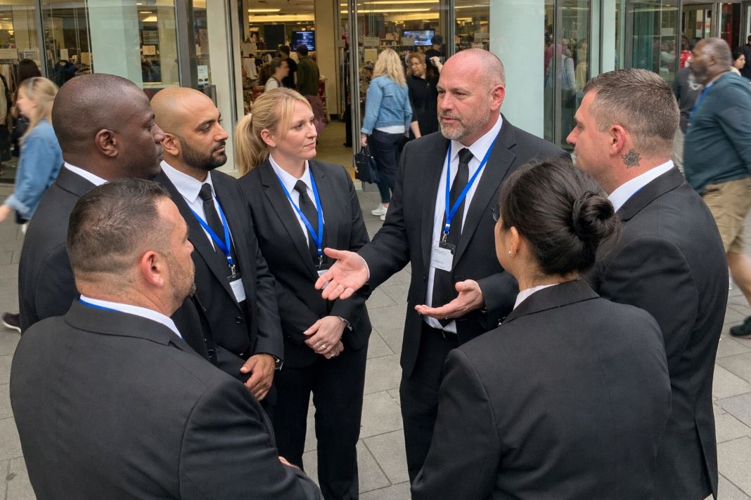 A representative image of a security briefing taking place outside of a shopping centre