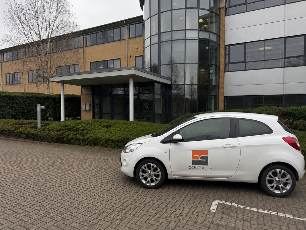 Double Check Security Group branded car parked outside a UK commercial office building