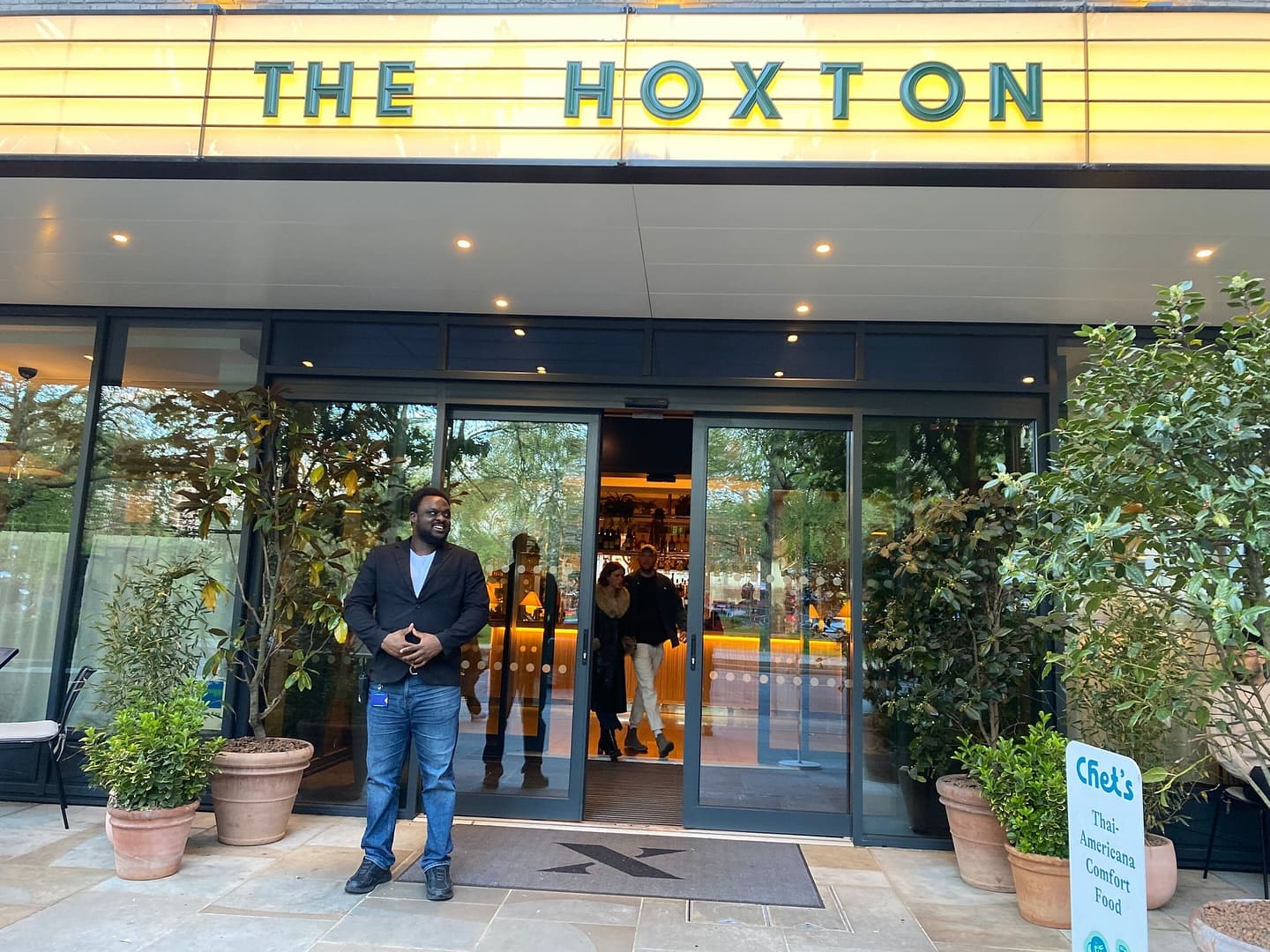 Hospitality security officer providing professional door supervision outside luxury hotel entrance safely.