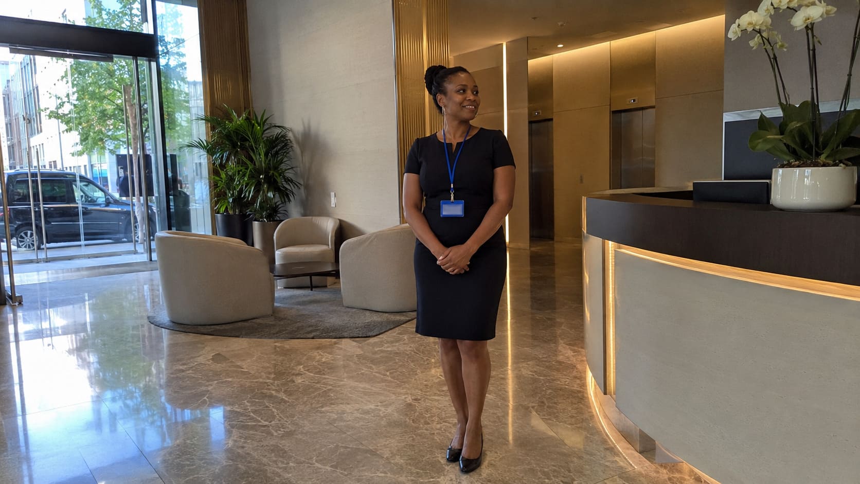Receptionist standing beside a premium office reception counter - Illustrative Image