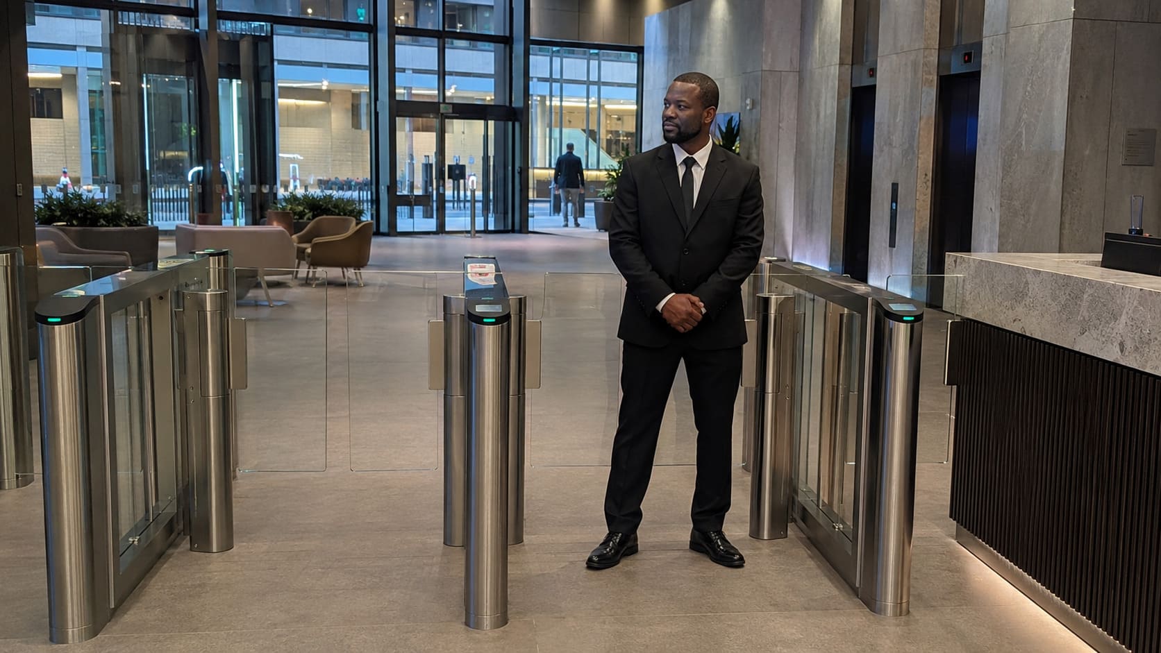 Security officer monitoring office access-control gates - Illustrative Image Security officer monitoring office access-control gates - Illustrative Image