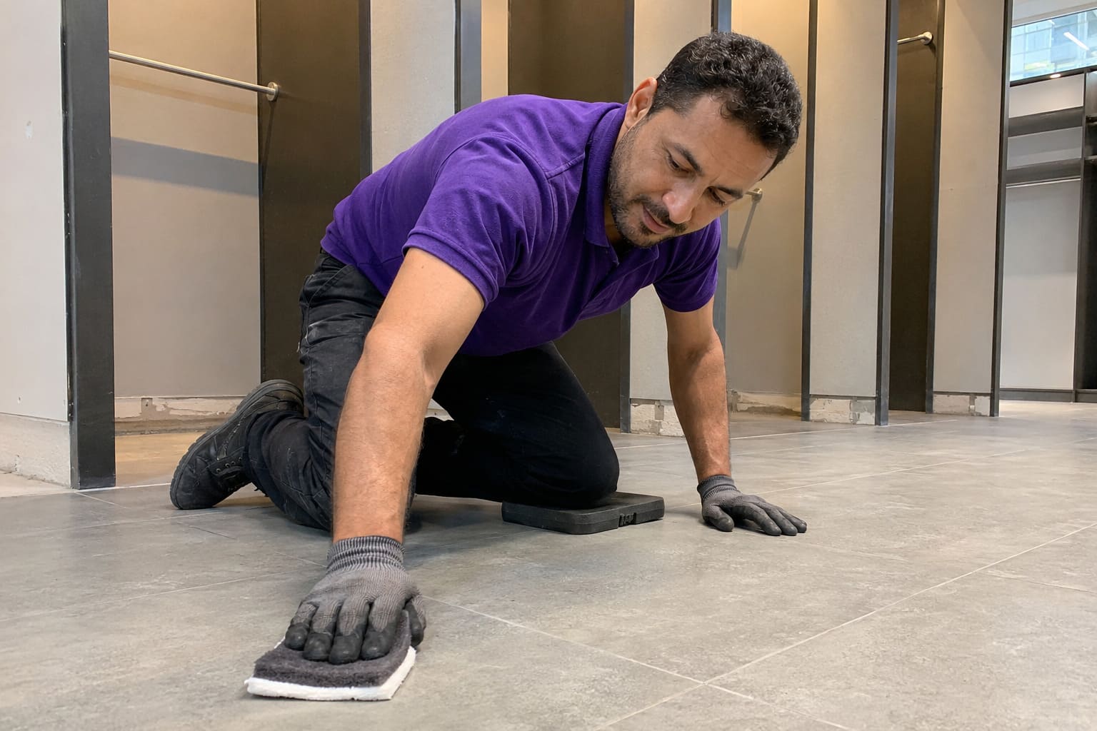 After builders cleaner removing grout residue from newly fitted store floor After builders cleaner removing grout residue from newly fitted store floor