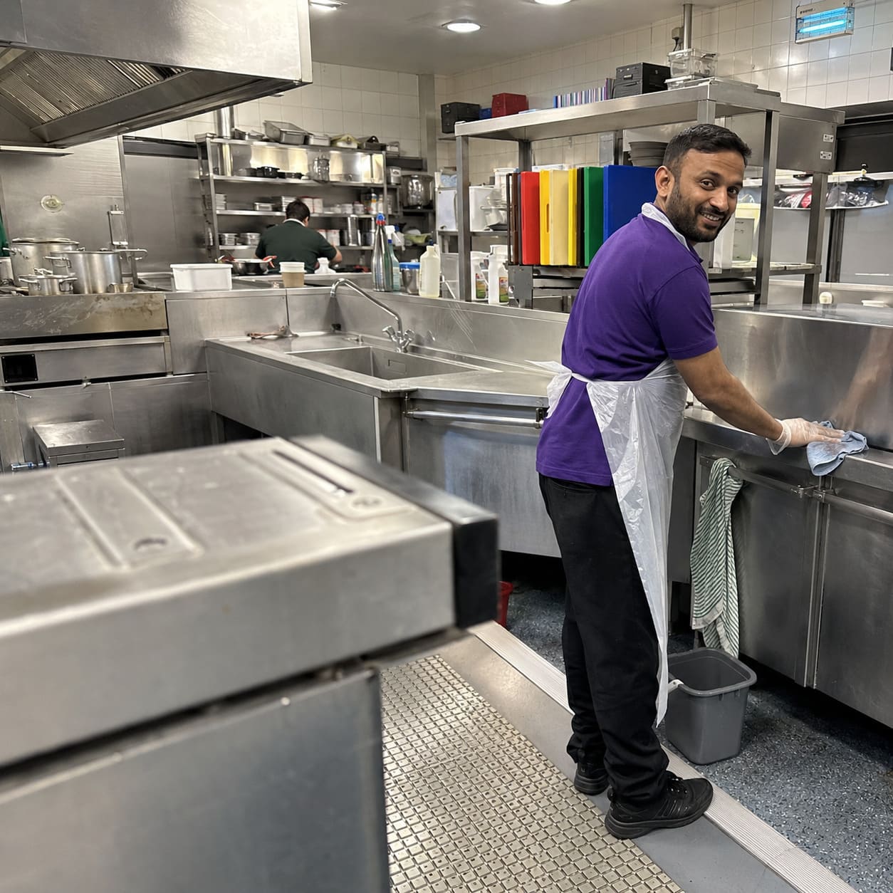 Commercial kitchen cleaner sanitising stainless steel preparation surfaces