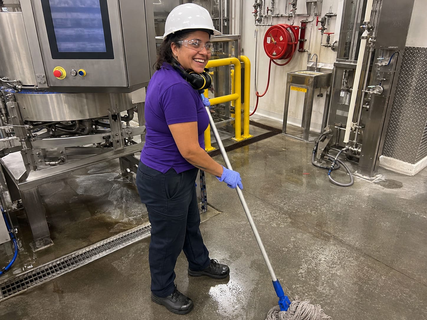 Cleaner mopping factory floor