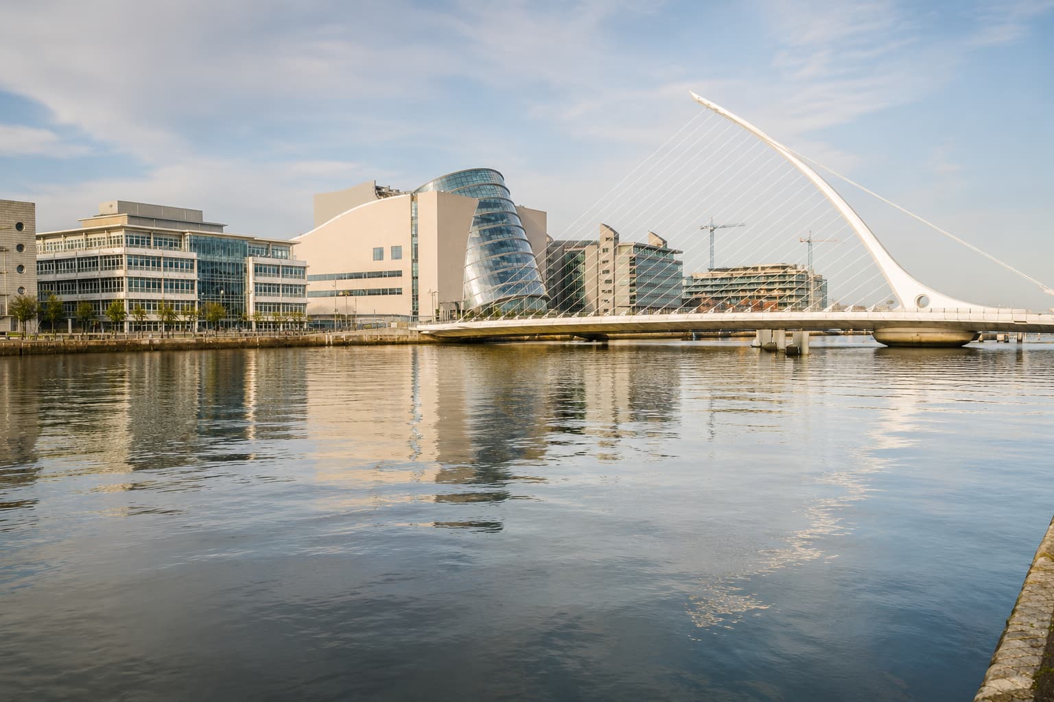 Samuel Beckett Bridge and Dublin Docklands viewed across the River Liffey in daylight.