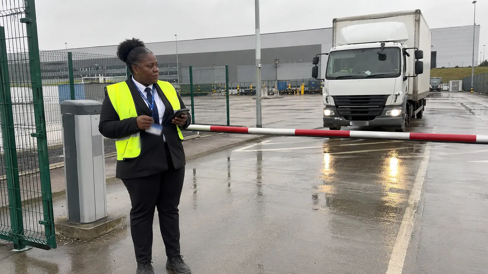 Security officer checking vehicle access at logistics gate - Illustrative Image
